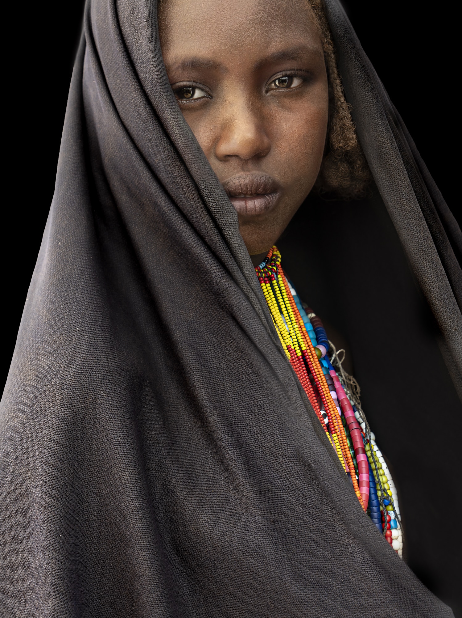 Young girl with black wrap from tribe in ethiopia.