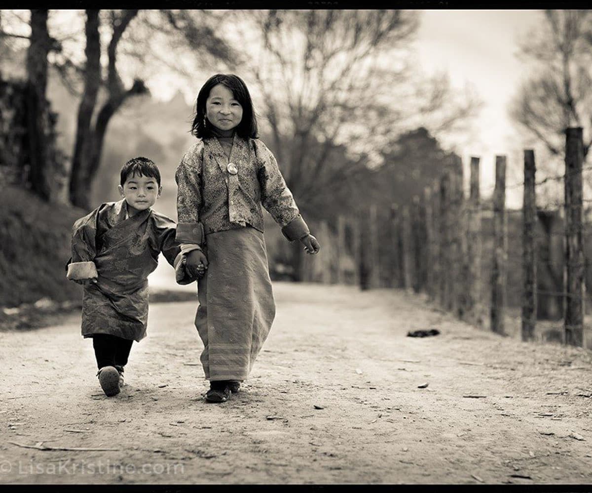 Children in Bhutan holding hands and walking together