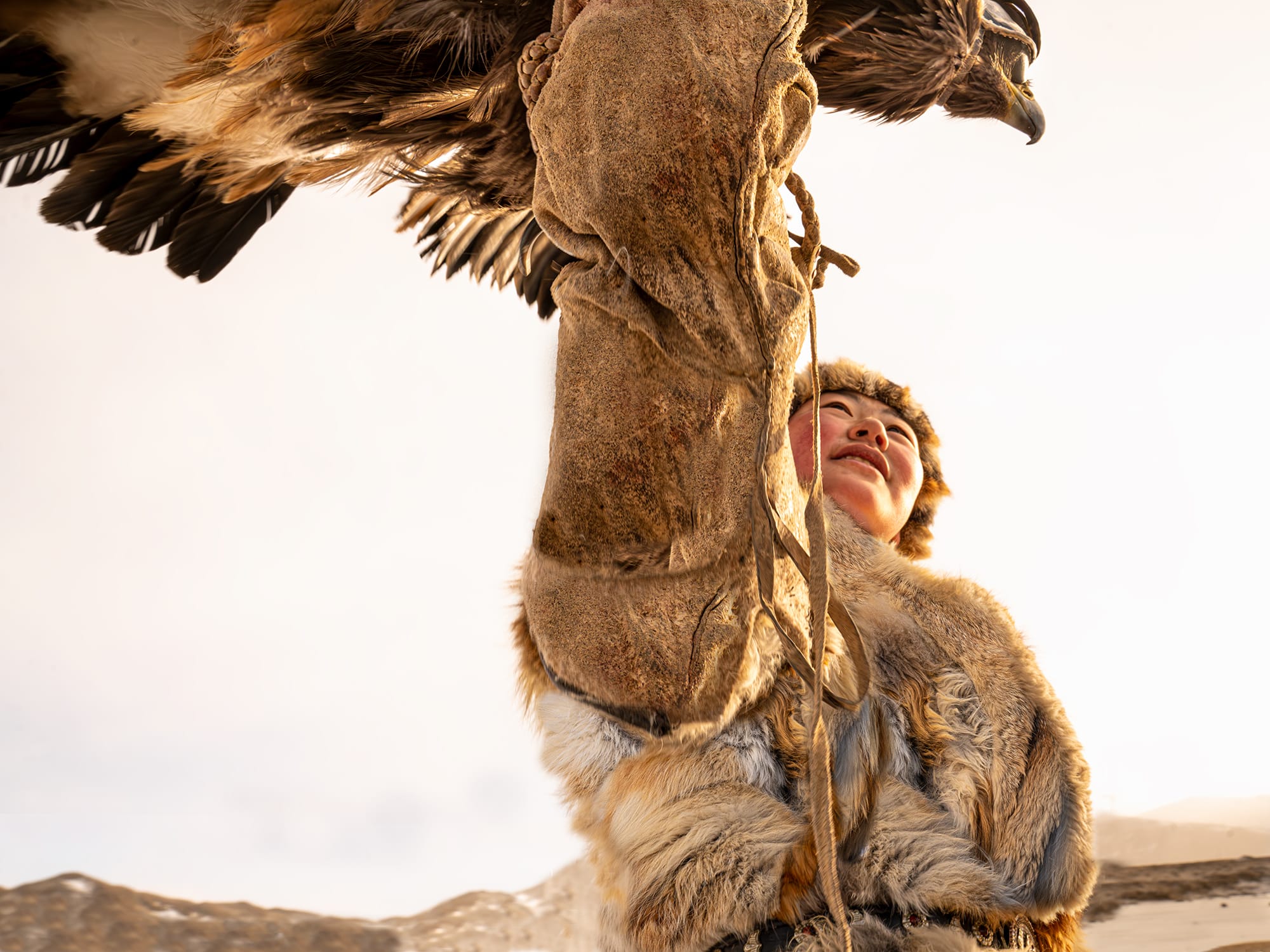 An image of strength, of infinite collaboration, a young female hunter in Mongolia and her partner, a magnificent golden eagle.