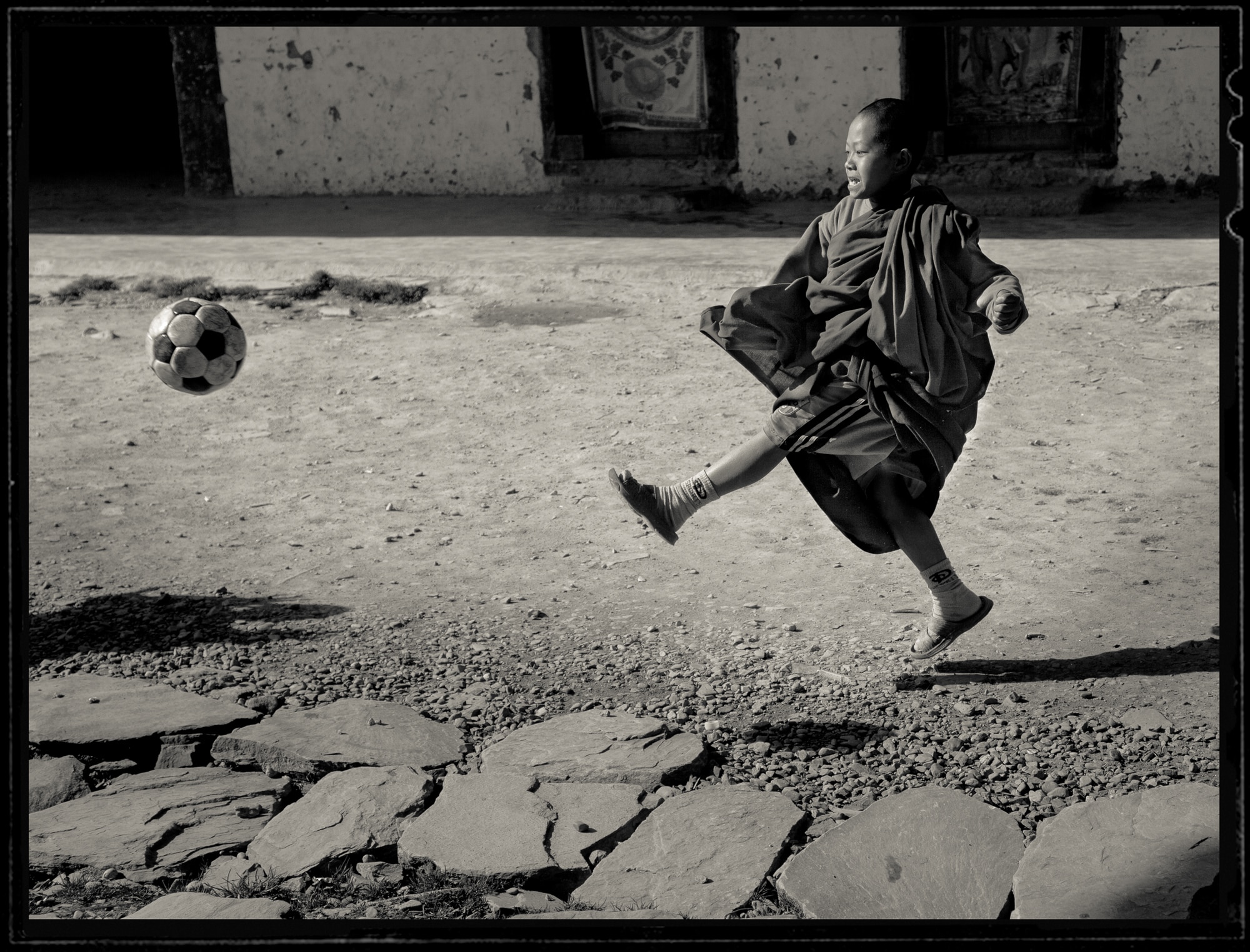 Kicking a soccer ball in Bhutan