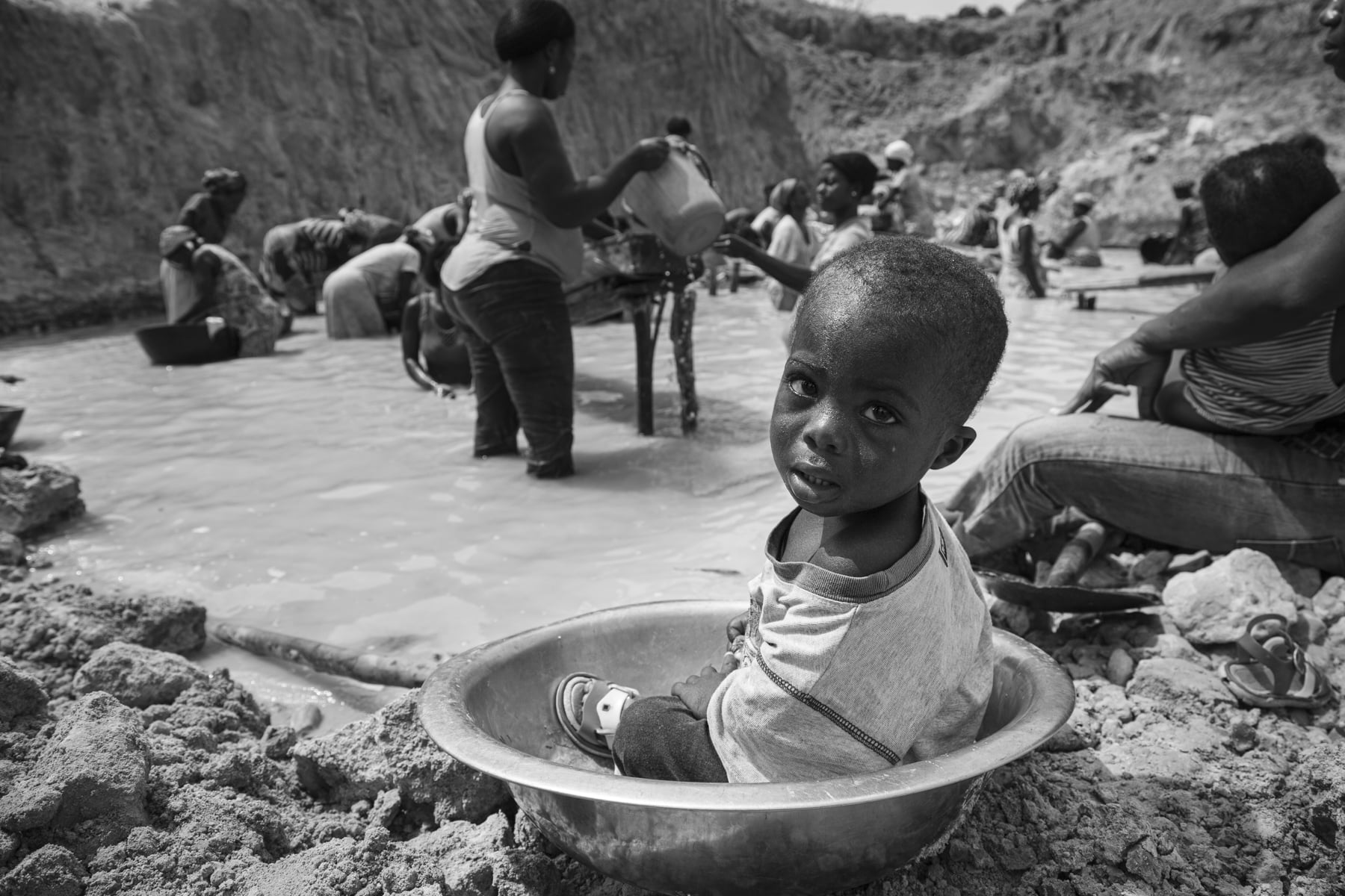 Baby in a gold mining pan in Ghana