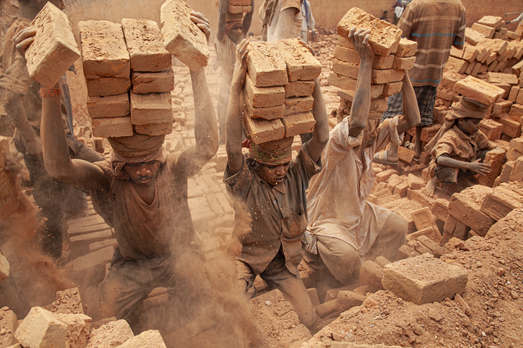 Men carrying bricks on their heads in Nepal