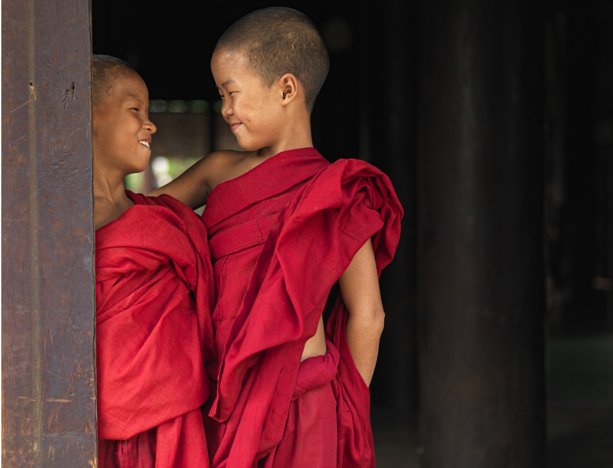 Two novice monks in Mandalay exchange a glance