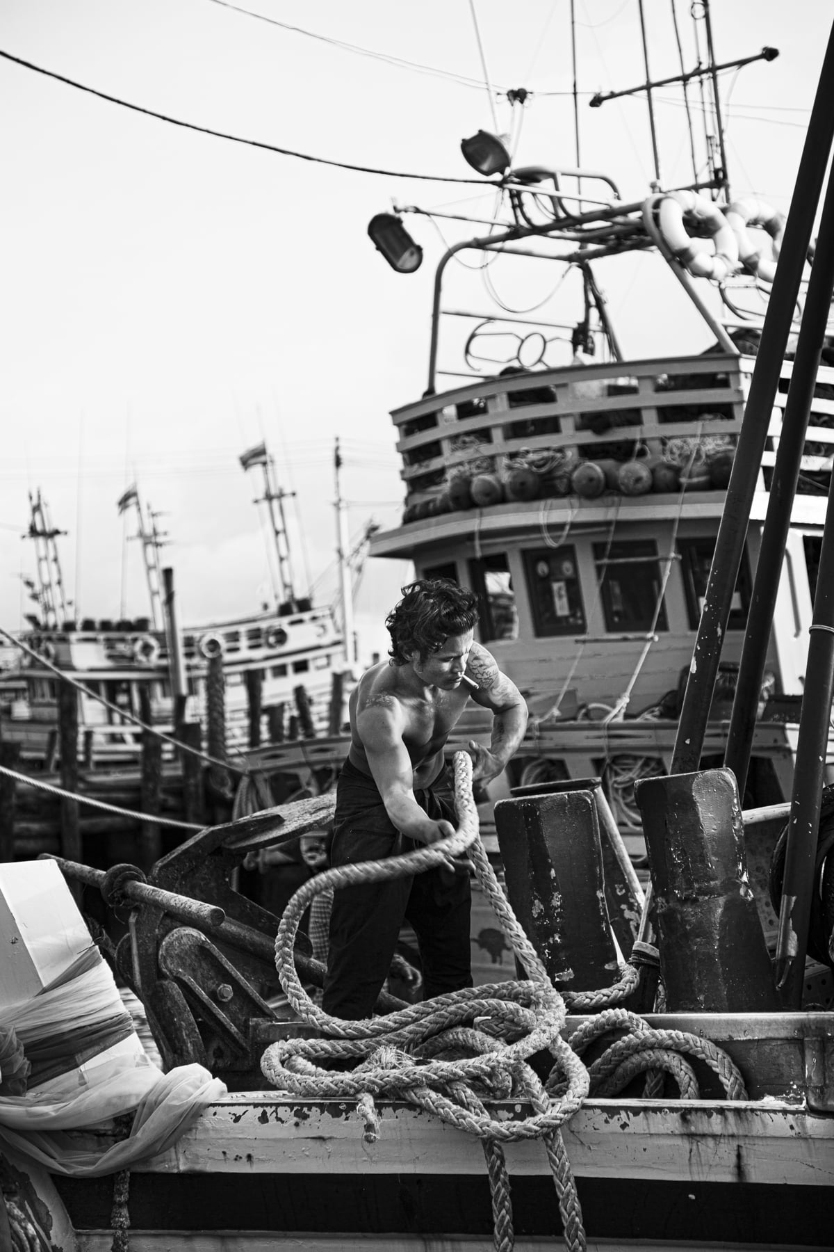 Man hoisting a rope out of the water in Thailand