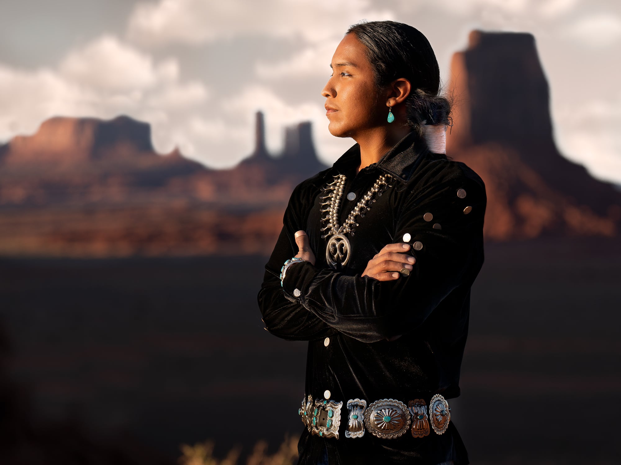 A young man and member of the Diné Navajo Nation gazes into the sunlight in his ancestral homeland. Land of the Diné
