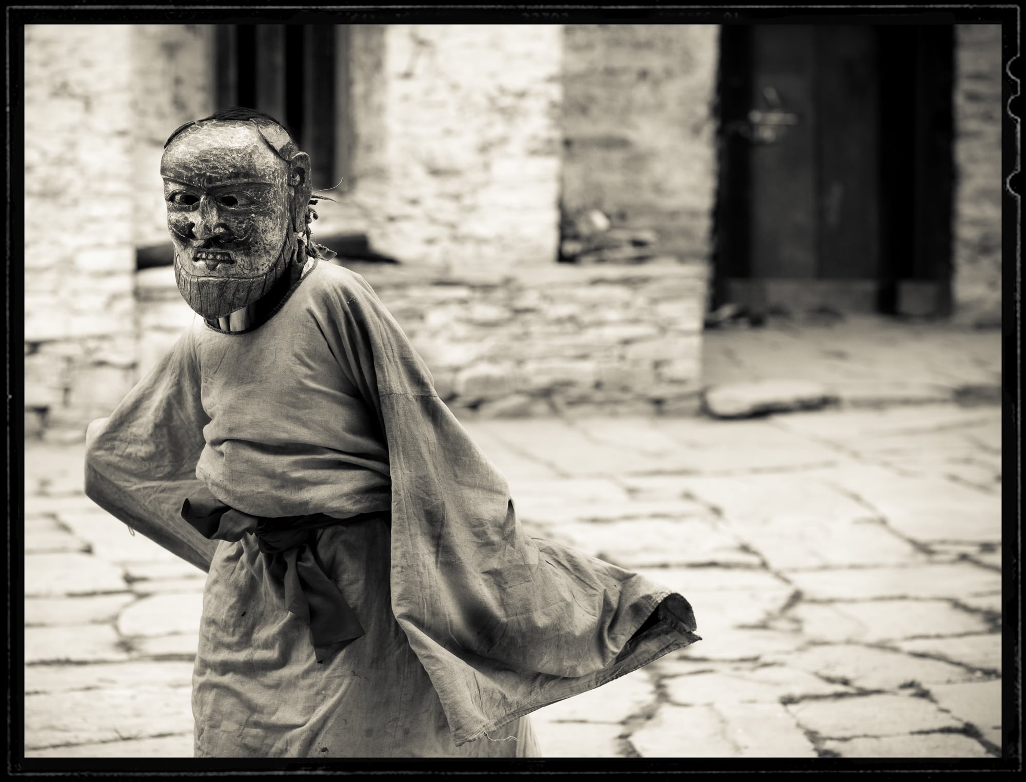 Child dancing and wearing a mask in Bhutan