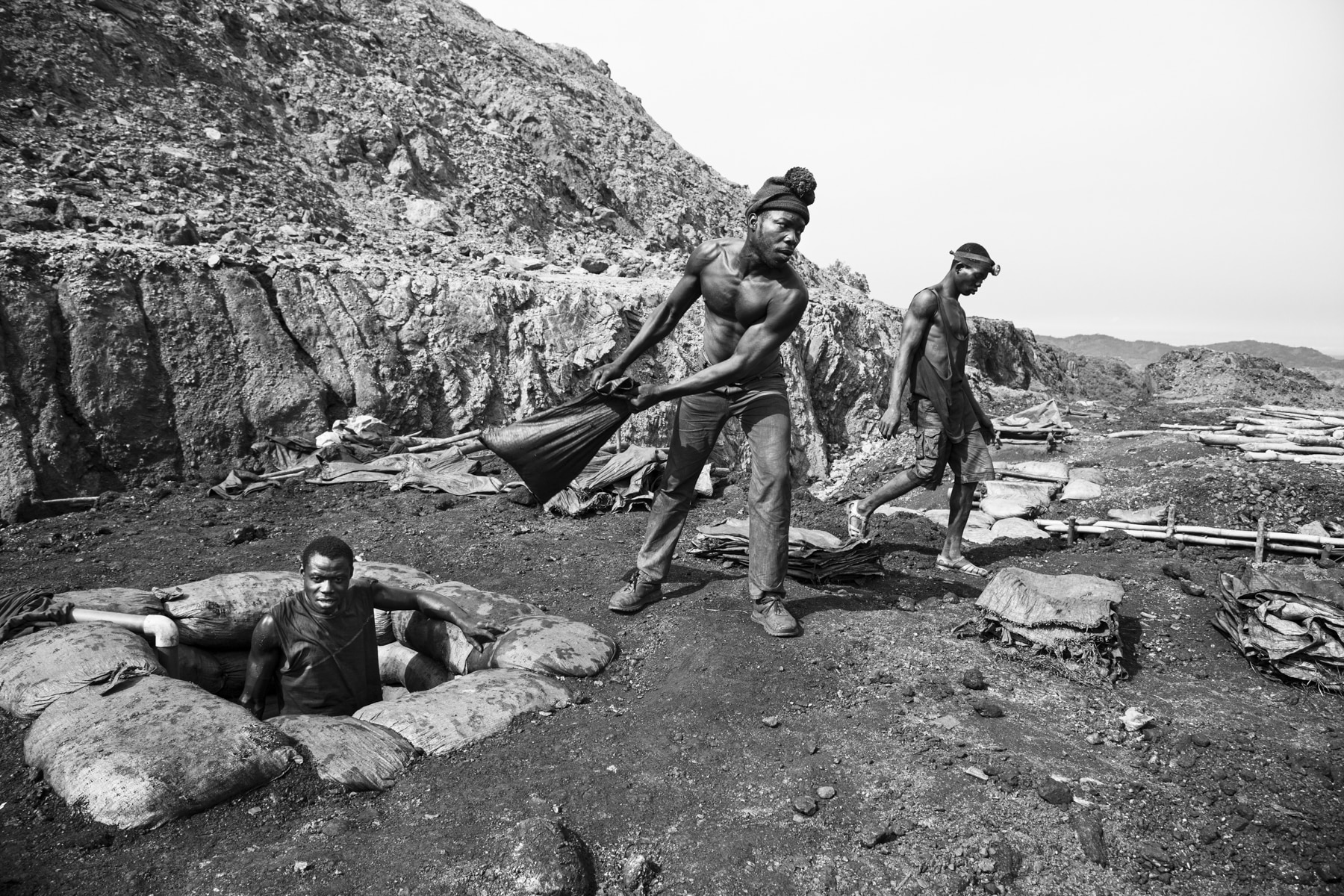 Men tossing stacks of stones in Ghana