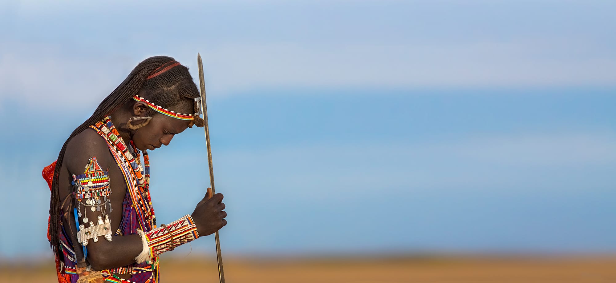 The warrior with his spear and beads serves also to emphasize the enormous space in front of him.